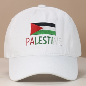Close-up of Palestine flag embroidery and text on a white cotton baseball cap