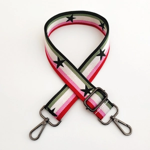Macro detail of the colorful star pattern nylon strap with gunmetal swivel hooks
