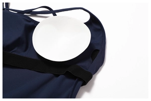 Detailed macro view of removable white padding inserts in a navy blue yoga jumpsuit