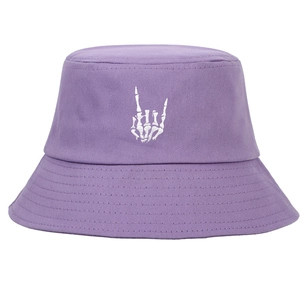 Detail of purple cotton bucket hat featuring white skull hand embroidery and stitched brim