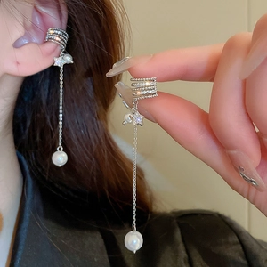Detail of silver star and moon tassel earring with sparkling cubic zirconia and pearls