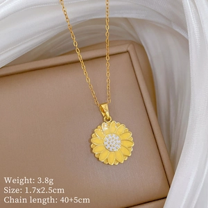 Macro shot of gold sunflower pendant with yellow petals on silk fabric, 40+5cm length