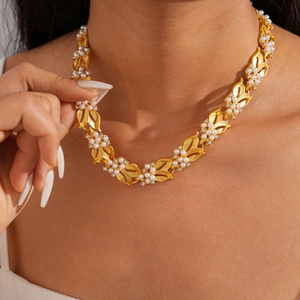 Elegant gold leaf necklace with pearls and rhinestones on model in vintage style