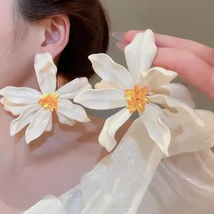 Exaggerated large white acrylic flower earrings with yellow stamen for vacation style