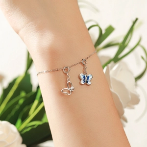 Elegant 925 sterling silver butterfly bracelet with blue enamel charm on woman wrist
