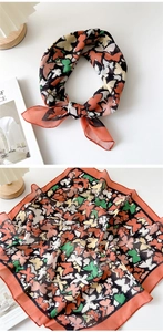 Detail of soft cotton linen square scarf with floral pattern and red hemmed edges