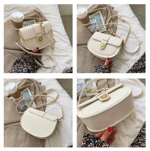Detail shots of white crocodile pattern saddle bag with gold buckle and chain strap