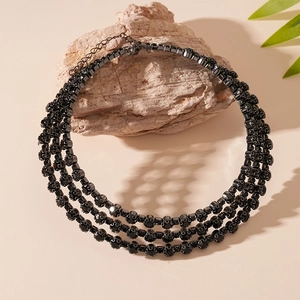 Detail of three-layer black rhinestone choker with adjustable lobster clasp on stone