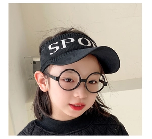 Detail of children's black sun visor with white SPORT embroidery and breathable open top