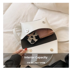 Detail view of the white crossbody bag interior showing phone and wallet storage