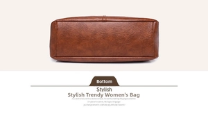 Detailed macro view of the brown leather bag base showing lychee texture and fine stitching