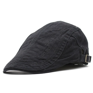 Side detail of black ivy cap showing metal buckle and GD-YST embroidery on cotton fabric