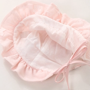 Pink lace baby bonnet with floral embroidery and ruffles for sun protection