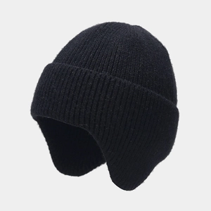 Detail of black rib-knit trapper hat showing thick wool texture and warm earflaps