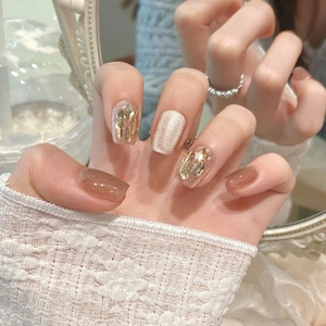Champagne cat eye press-on nails with sparkling golden flakes and shell texture