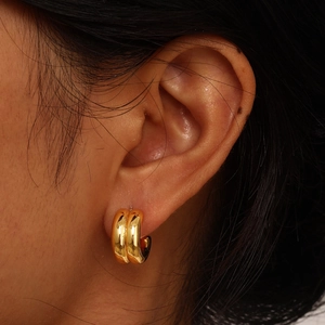 Chic double-row gold stainless steel hoop earrings shown in a realistic ear wearing view