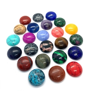 Assorted natural stone round cabochons including turquoise and amethyst on white background