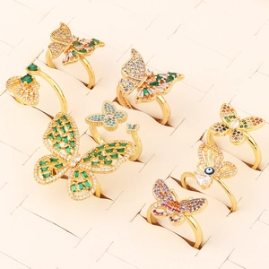 Macro shot of assorted gold butterfly rings with colorful cubic zirconia on jewelry tray