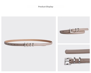 Detail view of thin leather belt for women showing silver metal buckle and fine stitching