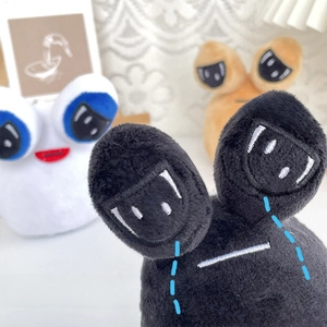 Close-up of soft plush animal pendants with large eyes embroidery and fuzzy texture