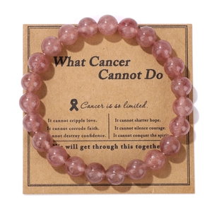Close-up of pink natural stone bead bracelet on a motivational brown kraft card