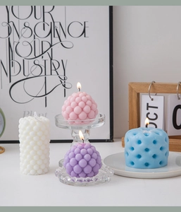 Artistic scented candles with bubble and grape textures in pastel colors for home decor