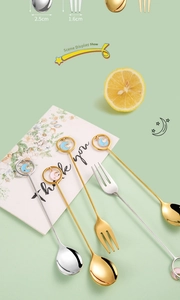 Detailed view of 304 stainless steel star and moon dessert spoon and fork set in gold