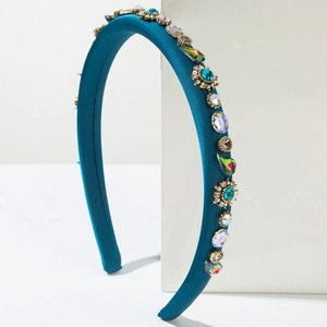 Detailed close-up of dark teal satin headband with handcrafted floral crystal gems
