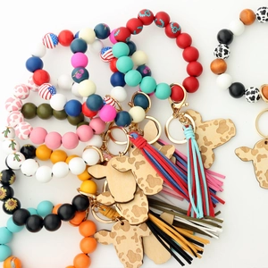Detail of western cowboy wristlet with cow head pendant, tassels, and colorful beads