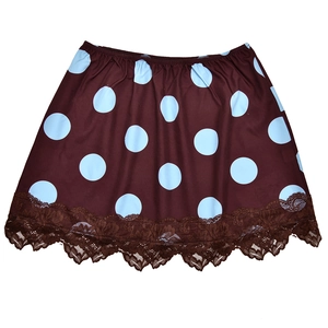 Detailed view of dark brown polka dot skirt with elastic waist and lace trim hem
