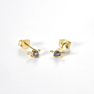 Detailed close-up of golden S925 silver heart arrow stud earrings with blue gems