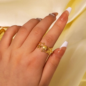 Adjustable 18K gold stainless steel ring featuring starfish and seashell marine charms