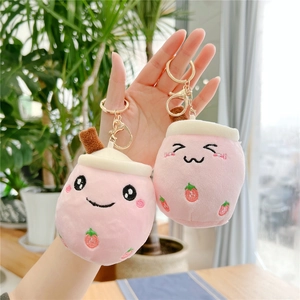 Pink plush milk tea cup keychains with strawberry embroidery and golden metal clasps