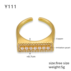 Detailed view of adjustable copper ring featuring white imitation pearls and crystal inlay