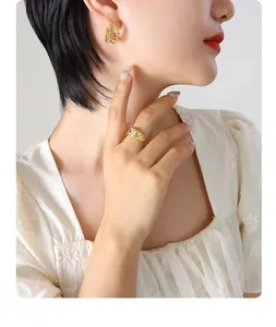 Detailed view of elegant four-layer gold C-shaped earrings with inlaid zircon on model