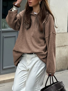 Detailed street style shot of a loose fit brown knit hooded sweater for women