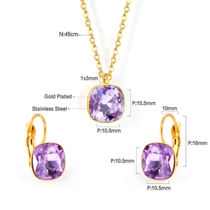 Detailed view of gold plated jewelry set with purple square cut crystals on white background