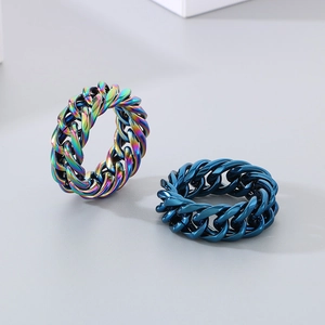Detail of multi-colored and deep blue Cuban chain rings in polished titanium steel