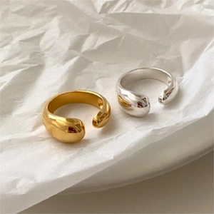 Detailed macro of S925 sterling silver stamp on minimalist gold and silver teardrop rings