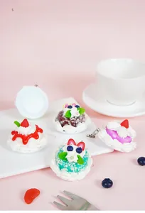 Detailed close-up of colorful resin mini cake charms with realistic fruit and cream textures
