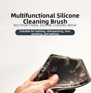 Close-up of a multifunctional grey silicone brush creating rich foam for body cleaning