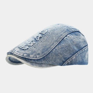 Detail of washed denim ivy cap with vintage distressed holes and white embroidery