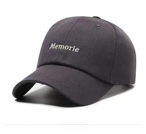 Detail of embroidered Memorie letter logo on charcoal grey cotton baseball cap
