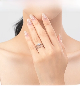 Close-up of elegant S925 silver Mobius ring set with round cut stone on model hand