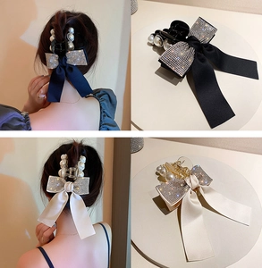Detail shot of mesh flower hair claws with pearls and rhinestones in black and beige