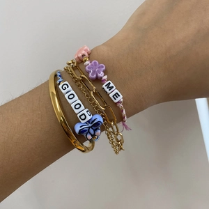 Colorful layered bracelet set with gold bangles, floral cords and GOOD ME letter beads