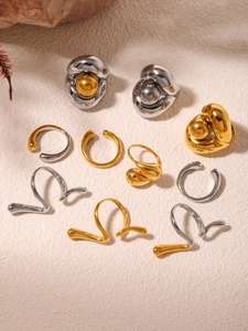 Detailed view of minimalist gold and silver earrings with a liquid metal texture design