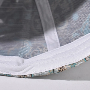 Detailed macro view of the inner mesh lining and blue-gold jacquard fabric on the cap