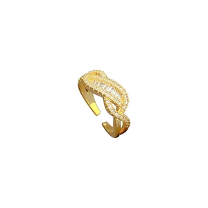 Adjustable gold twisted ring with rectangular and round pavé zircon stones on white background