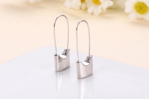 Detailed macro view of 925 sterling silver cat-shaped hook earrings with polished mirror finish
